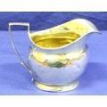 Georgian silver cream jug of oval bright cut form with reeded rim and angled handle,