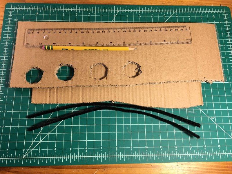 The pipe cleaner guide With some thick width cardboard, cut out rectangle that is 4cm by 24cm. Draw a line through the center at 2 cm.