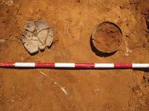 destroyed by site development works; the tomb was only traceable by the remains of a gray ashen stain from which were recovered just two ceramic vessels in situ: a small carinated and a small open