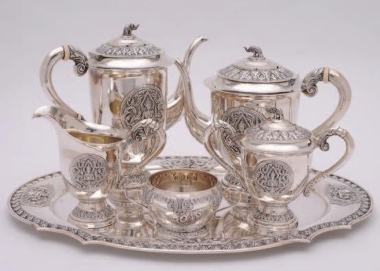 88 88 A Far Eastern five piece silver tea and coffee service with matching oval tray, the service marked Sterling - Thailand, each piece of circular pedestal form decorated with roundels of deity