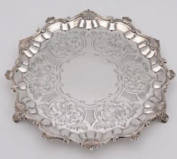 200-250 104 A Victorian silver salver, maker Hands & Sons, London, 1879, of shaped circular form, the centre engraved with foliate