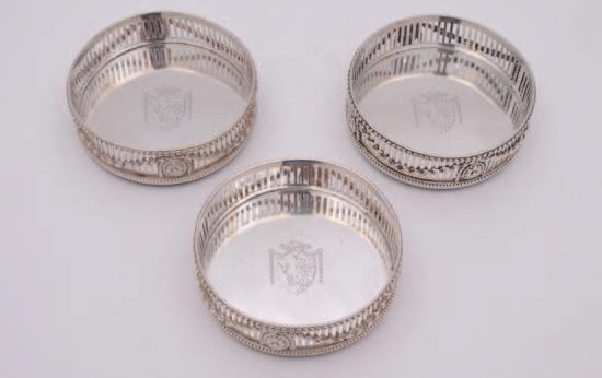 126 A set of three George III silver wine coasters, maker Robert Hennell, London, 1772, the pierced sides embellished with applied swags and classical