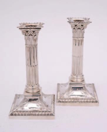 136 136 A pair of late Victorian silver Corinthian column candlesticks, maker JKB, Sheffield, 1890, on foliate embellished square bases with gadrooned borders and detachable nozzles, 18cm high,