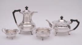 18 19 22 18 A George V four piece silver tea set, maker H A, Sheffield, 1910, of a squat circular form, scroll handles on three hoof feet, the hot water