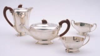 300-400 42 An Elizabeth II silver four piece tea set maker Garrad & Co, Sheffield, 1964, in the Art Deco style, comprising of a tea pot and hot water jug, a matching sugar basin and a