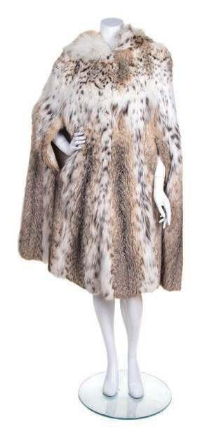 AUCTION HIGHLIGHTS 276 250 282 250 A Lynx Fur Cape, with a hood, hook and eye closure at the neck,
