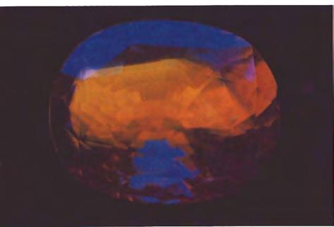 Figure 19. Parti-colored sapphire pictured in figure 18 as it appears when exposed to longwave ultraviolet light. Figure 20. Cat's-eye sillimanite, 1.99 cts.
