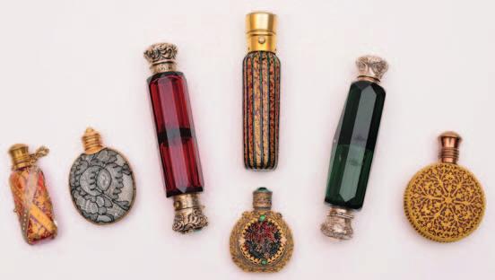 47 47 45 47 46 47 50 45 A Victorian ruby glass and silver mounted double ended scent bottle, initialled, the hinged stopper with horseshoe shaped mount inset with turquoise, 13cm. long.