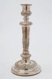 61 64 66 61 A George III silver candlestick, maker John & Thomas Settle, Sheffield, 1818, decorated with foliate scrollwork borders, the base loaded, 32cm high.