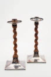 12 11 11 A pair of George V silver mounted candlesticks, in the Arts & Crafts style, maker Alfred Ernest Gutmann, Chester 1913, the