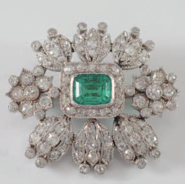 155 An emerald and diamond mounted oval brooch with central emerald-cut emerald approximately 6.5mm x 5.