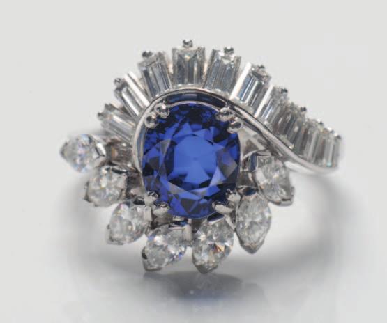 168 Boucheron. A sapphire and diamond cluster ring with central oval sapphire approximately 8mm long x 6.