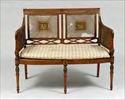 Lot #247: Edwardian George III-Style Paint-Decorated Satinwood and Cane Settee 35 1/2 x 44 1/4 x 22 3/4 in. Provenance: Property of the Estimate: $ 800.00 - $ 1200.