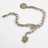 1/4", fitted with padlock fastener & safety chain, complete with five various charms, an open curb bracelet, approx.