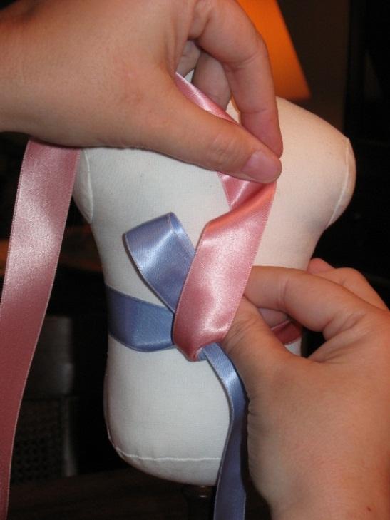 Form a loop with the left ribbon tie (blue).