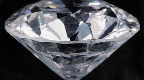 trigons on natural diamond crystals (a photograph of similar triangular growth hillocks on a synthetic diamond is shown as figure 5 on p. 48 of the Spring 1997 issue of Gems & Gemology).