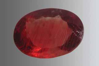 Figure 5. Lindi, Tanzania, is reportedly the source of these samples of almandine-spessartine. GIA Collection nos. 37613 (cut stone, 1.35 ct) and 37612 (crystal, 0.5 g); photo by Robert Weldon.