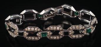 * 250-350 252 A French Art Deco silver and paste-set bracelet with colourless paste-set octagonal links between emerald coloured and black
