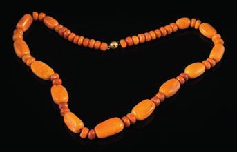 261 An amber bead single-string necklace comprising oblong beads interspersed with circular beads, largest oblong bead measures approximately 29mm long, 23.