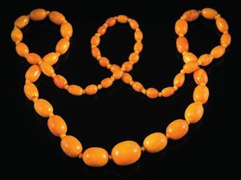 * 300-400 262 An amber bead single-string necklace with 54 individually knotted, oblong beads graduated from 7mm to 21mm, approximately 39gms gross weight.