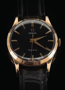 207 Omega. A gentleman s 9ct gold cased, manual wristwatch the black dial with baton markers, the winder with Omega emblem, the case approximately 33mm wide and on black Omega strap.
