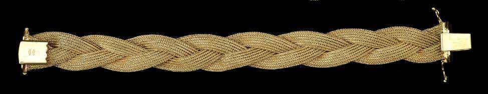 800-1000 100 A TRACK-LINK BRACELET, composed of articulated textured and polished chevron links, yellow precious metal, clasp and underside of tongue stamped 750, length 19.2cm, width 1.