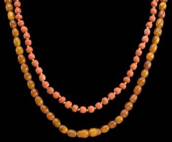 106 A CORAL BEAD NECKLACE, AN ENAMELLED FOB WATCH AND AN AMBER NECKLACE, the slightly graduated coral, Corallium rubrum, beads on knotted silk, to plain