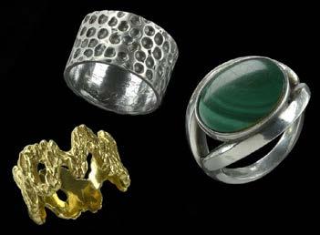 115 A DANISH SILVER AND MALACHITE RING BY GEORG JENSEN AND TWO FURTHER RINGS, the first collet set with an oval malachite panel, to a shaped bifurcated mount, signed, stamped 925s DENMARK and