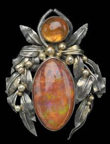 300-500 116 AN ARTS AND CRAFTS FIRE OPAL BROOCH, the marquise and round cabochon fire opals in closed back collet settings, within a stylized fruiting foliate wreath surround, mounted in white metal,
