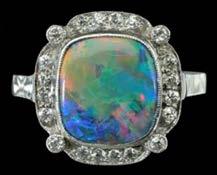 500-700 182 AN OPAL FIVE STONE RING, the five graduated cabochon opals claw set with pairs of diamond points between, one diamond replaced, mounted in 18ct yellow gold, hallmarked for Chester, 1903,