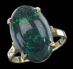 1200-1500 186 AN OPAL AND DIAMOND CLUSTER RING, the oval cabochon opal in four claw setting within a border of brilliant-cut diamonds, between