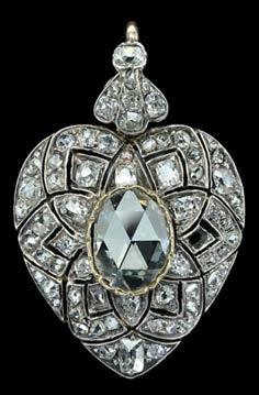 213 A LATE VICTORIAN DIAMOND HEART-SHAPED PENDANT, gold and silver mounted, centred with an oval rose-cut diamond, the surround set throughout with