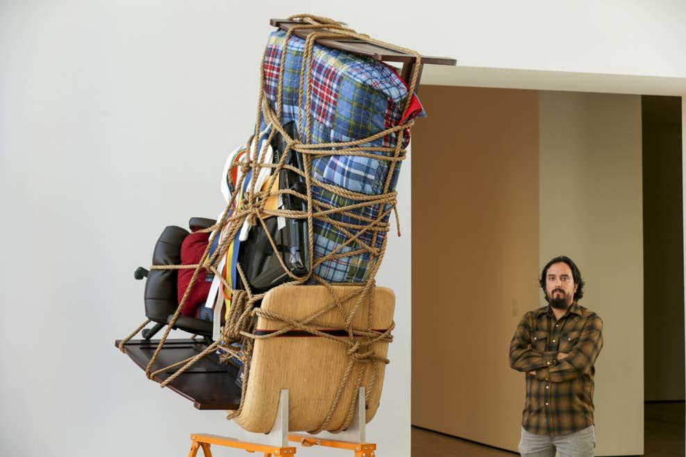 Page 3 of 9 Artist Camilo Ontiveros with a sculpture he created with the belongings of a DACA recipient.