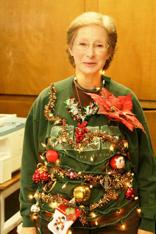 ..holiday decorated sweaters/vests with blinking reindeers, wreaths, or decorated trees on them.
