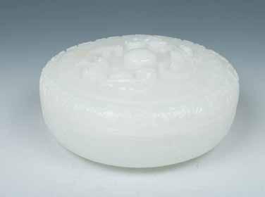 floral carving cover surmounted by the seated figure jade carving, the base with six characters Xuande seal and period. W:16.